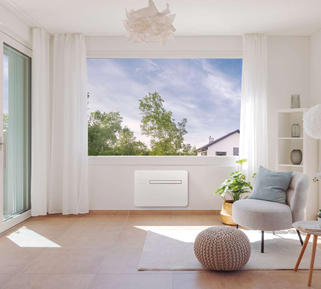 Panasonic RAC Solo installed beneath an open window in a bright living room